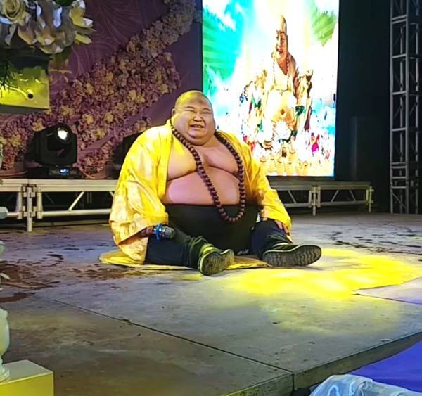 Chinese Man Makes a Living Posing as RealLife "Laughing Buddha"