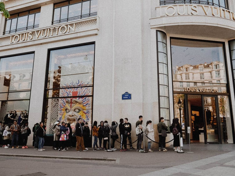 Japanese tourists queuing at Louis Vuitton store in Champs Elysees